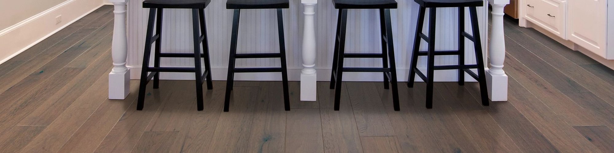 bar stools in kitchen with hardwood flooring